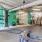 Fitness center with modern equipment, including cardio machines and weights, in a spacious and well-lit area