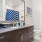 Well-lit bathroom featuring modern fixtures, a large mirror, and stylish tilework