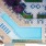 Aerial view of a pool area with lounge chairs, a well-maintained deck, and surrounding greenery