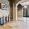 An office foyer at Vista Wilde Lake featuring exposed brick walls, arched doorways, a decorative console table, and large double doors leading to the outside